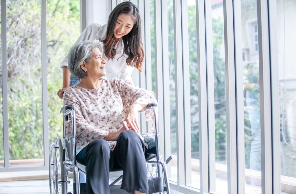 Older adult and younger adult sitting on a couch in serious conversation both appearing thoughtful and emotionally tense
