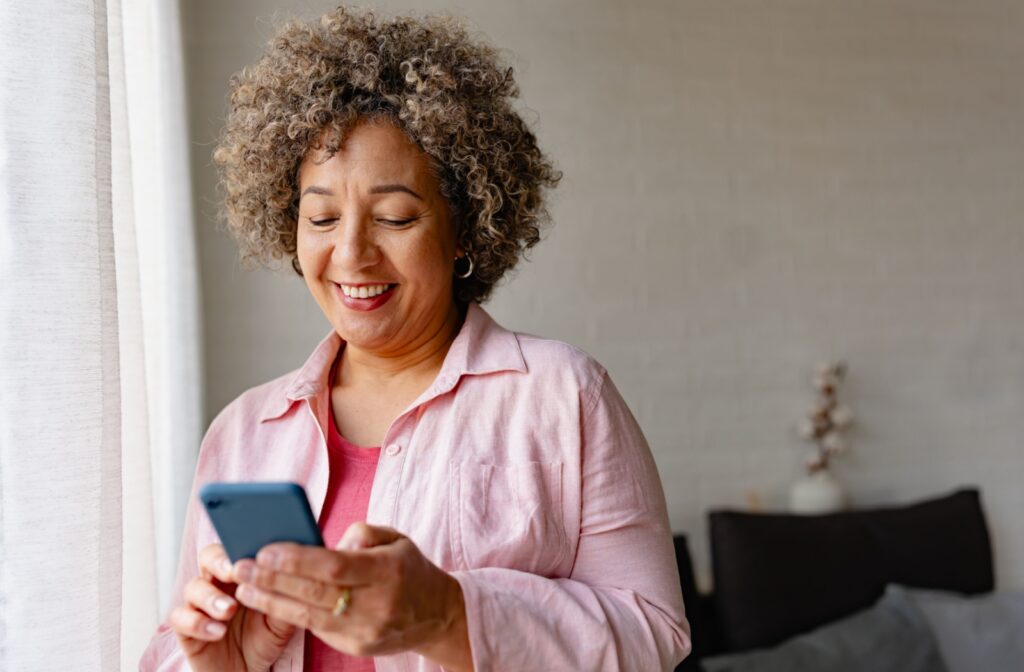 Senior woman using her smartphone as a memory aid or reminder tool.
