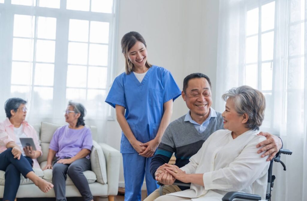A nurse checks in with some seniors as they socialize in communal areas of their senior living community